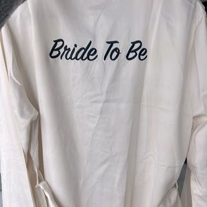 NWT ivory satin Fredericks of Hollywood “Bride to be” robe with black piping